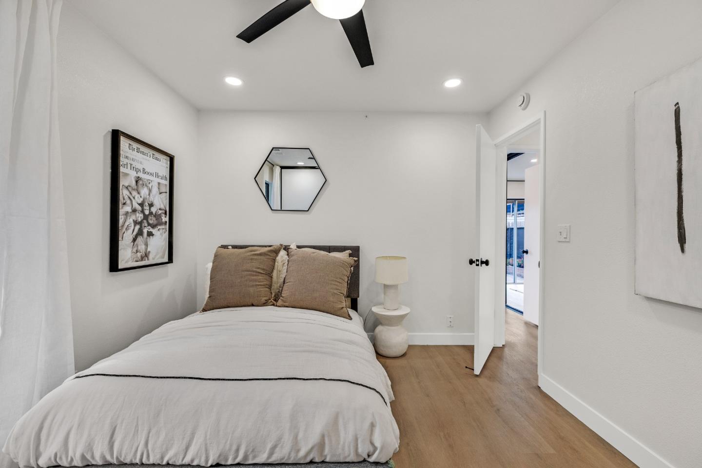 205 Red Oak Drive, Unit M Sunnyvale, CA 94086 - Photo 22 of 32 a bedroom with a large bed and a chandelier