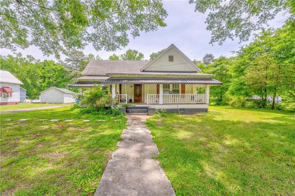 a front view of a house with yard and green space