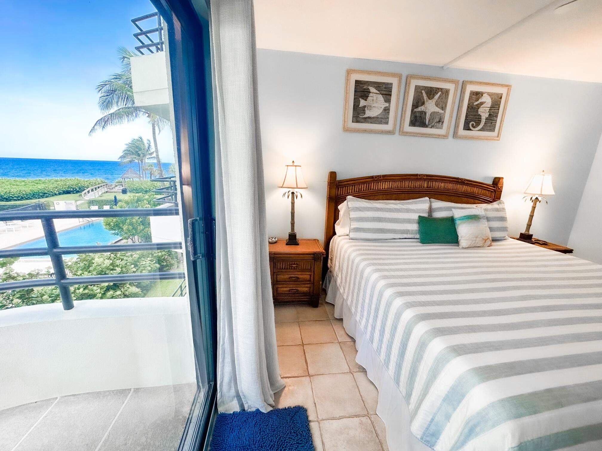 420 Celestial Way, Unit 301 Juno Beach, FL 33408 - Photo 20 of 51 a bedroom with a large bed and a window