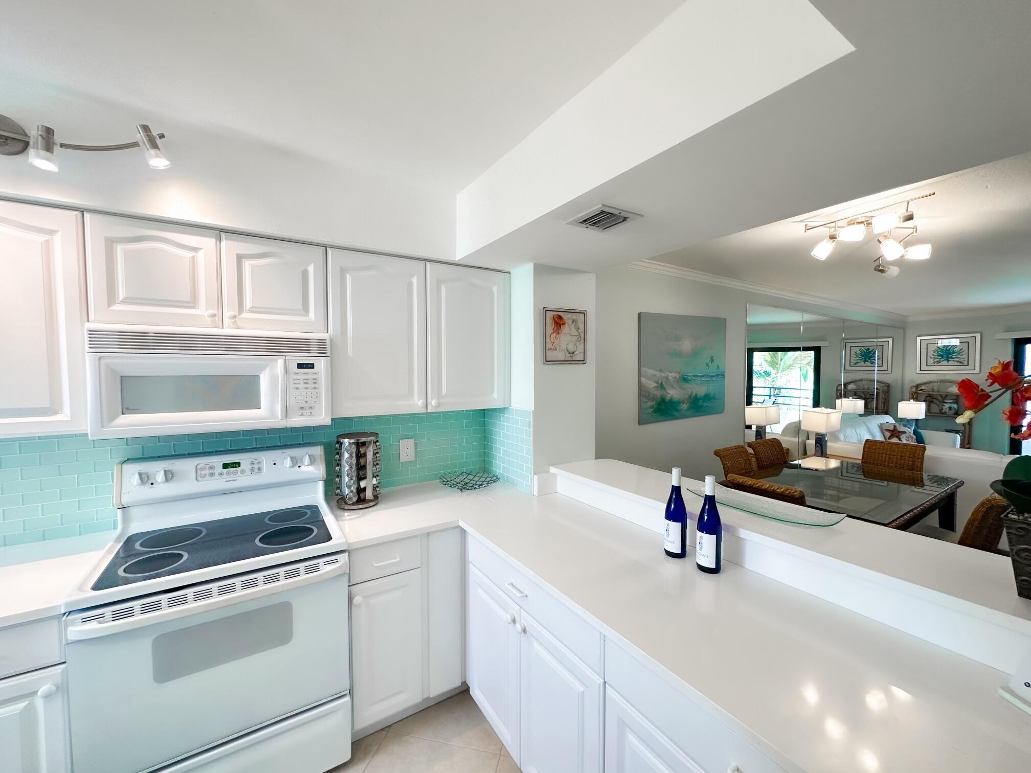 420 Celestial Way, Unit 301 Juno Beach, FL 33408 - Photo 26 of 51 a kitchen that has a sink and a stove in it