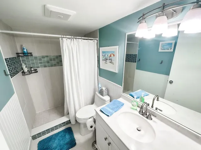 a bathroom with a sink toilet and shower