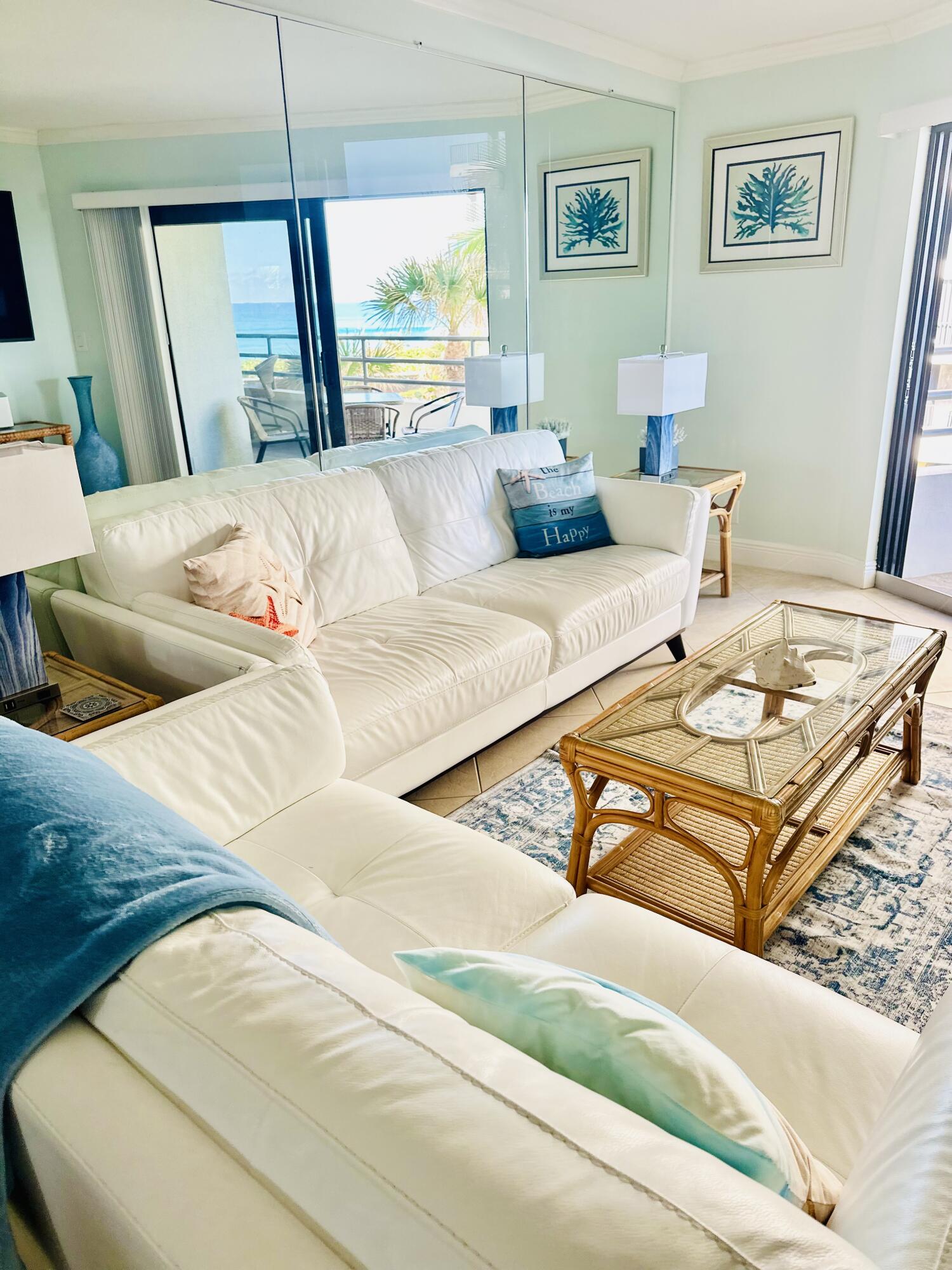 420 Celestial Way, Unit 301 Juno Beach, FL 33408 - Photo 32 of 51 a living room with a bed and a couch