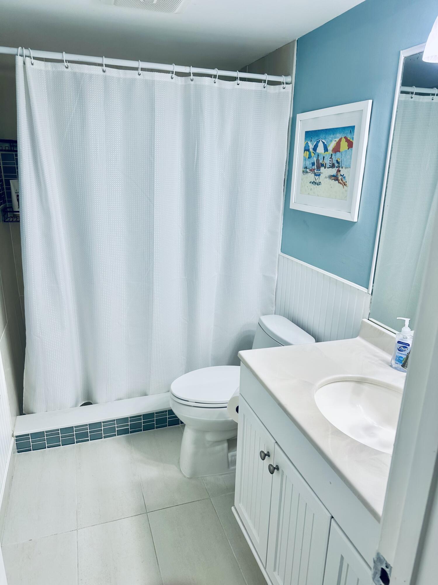 420 Celestial Way, Unit 301 Juno Beach, FL 33408 - Photo 43 of 51 a bathroom with a sink a toilet and shower