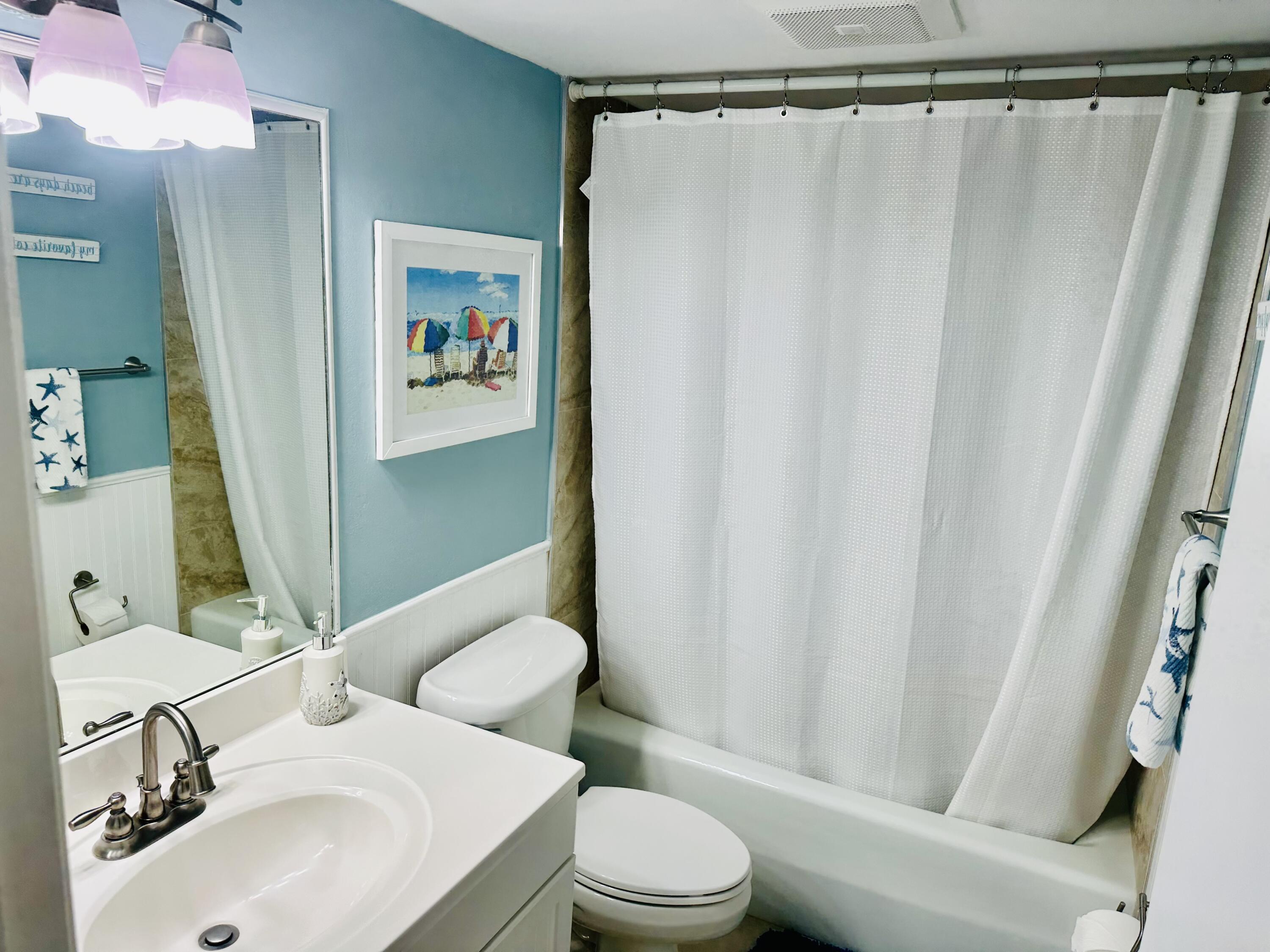 420 Celestial Way, Unit 301 Juno Beach, FL 33408 - Photo 44 of 51 a bathroom with a sink toilet and shower