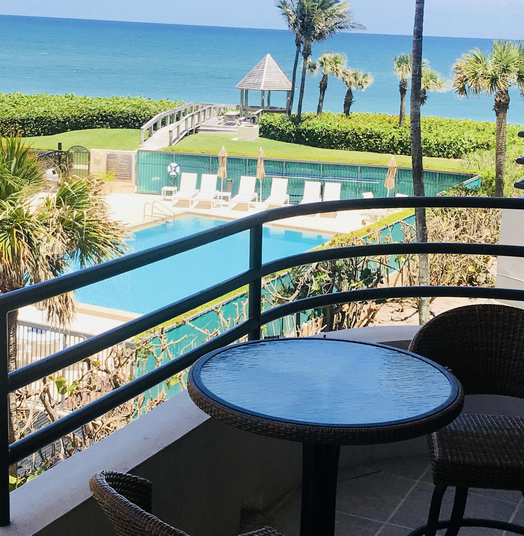 420 Celestial Way, Unit 301 Juno Beach, FL 33408 - Photo 46 of 51 a view of a chairs and table in patio