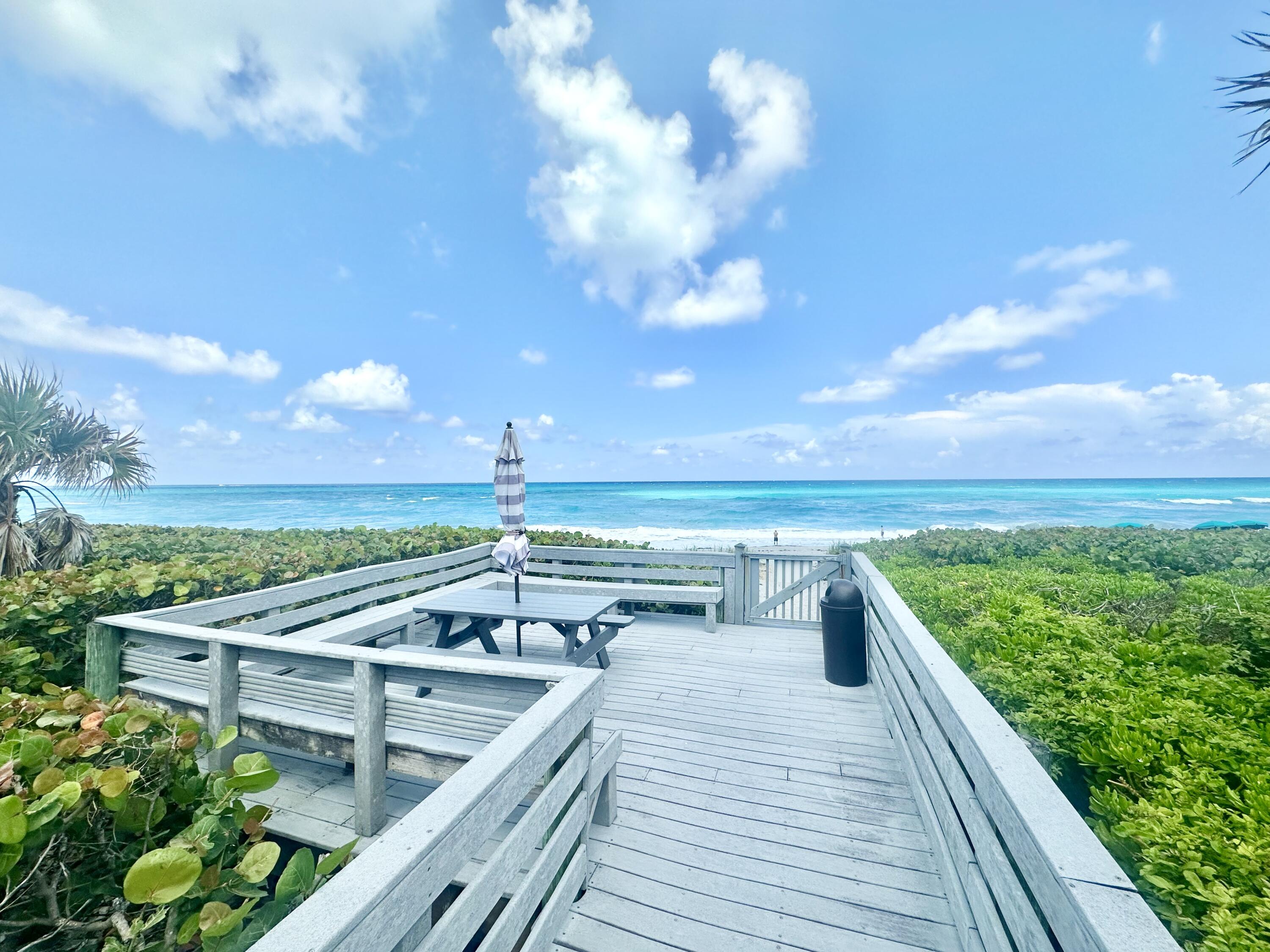 420 Celestial Way, Unit 301 Juno Beach, FL 33408 - Photo 8 of 51 a view of roof deck with a barbeque and wooden stairs