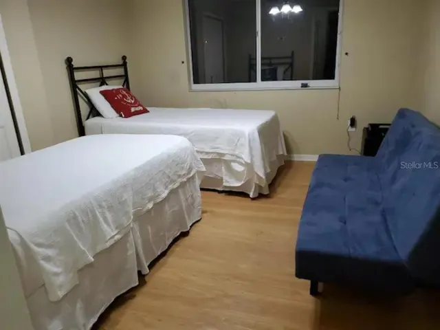 a bedroom with a bed and a chair
