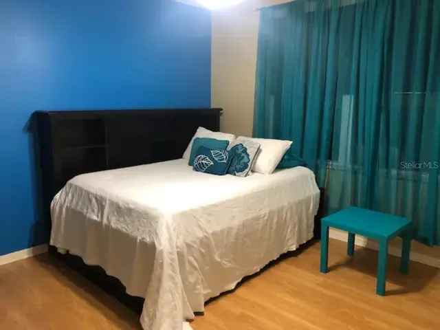 a bedroom with a bed and a mirror