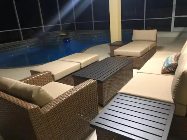 a balcony with wooden floor and outdoor seating