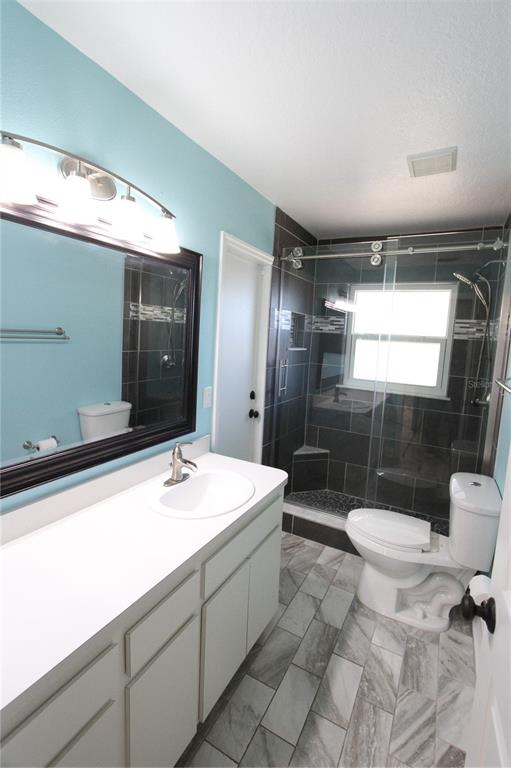 1414 Norwick Drive Lutz, FL 33559 - Photo 30 of 43 a bathroom with a sink toilet and shower