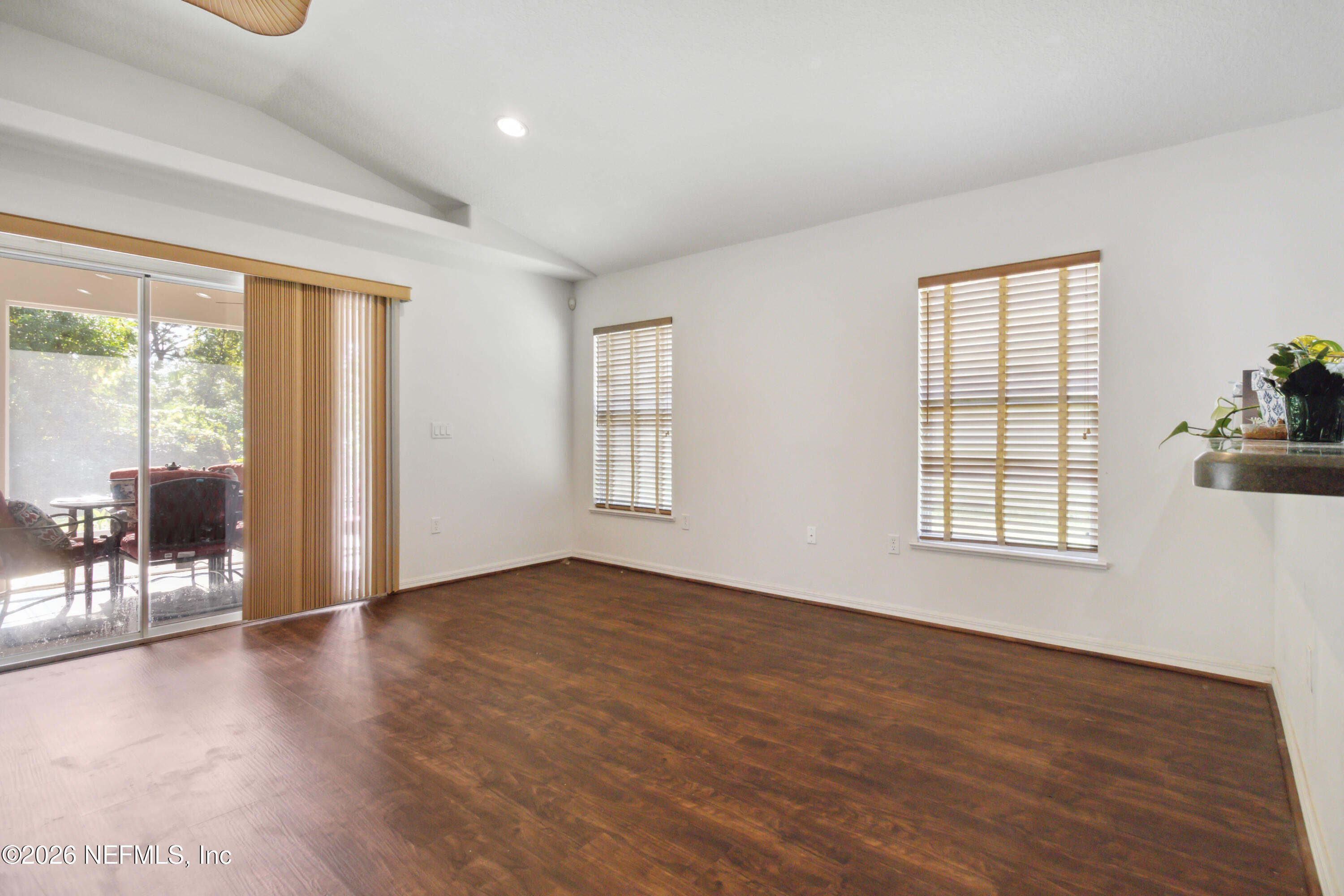 940 Tavernier Circle Northeast Palm Bay, FL 32905 - Photo 14 of 31 an empty room with wooden floor and windows