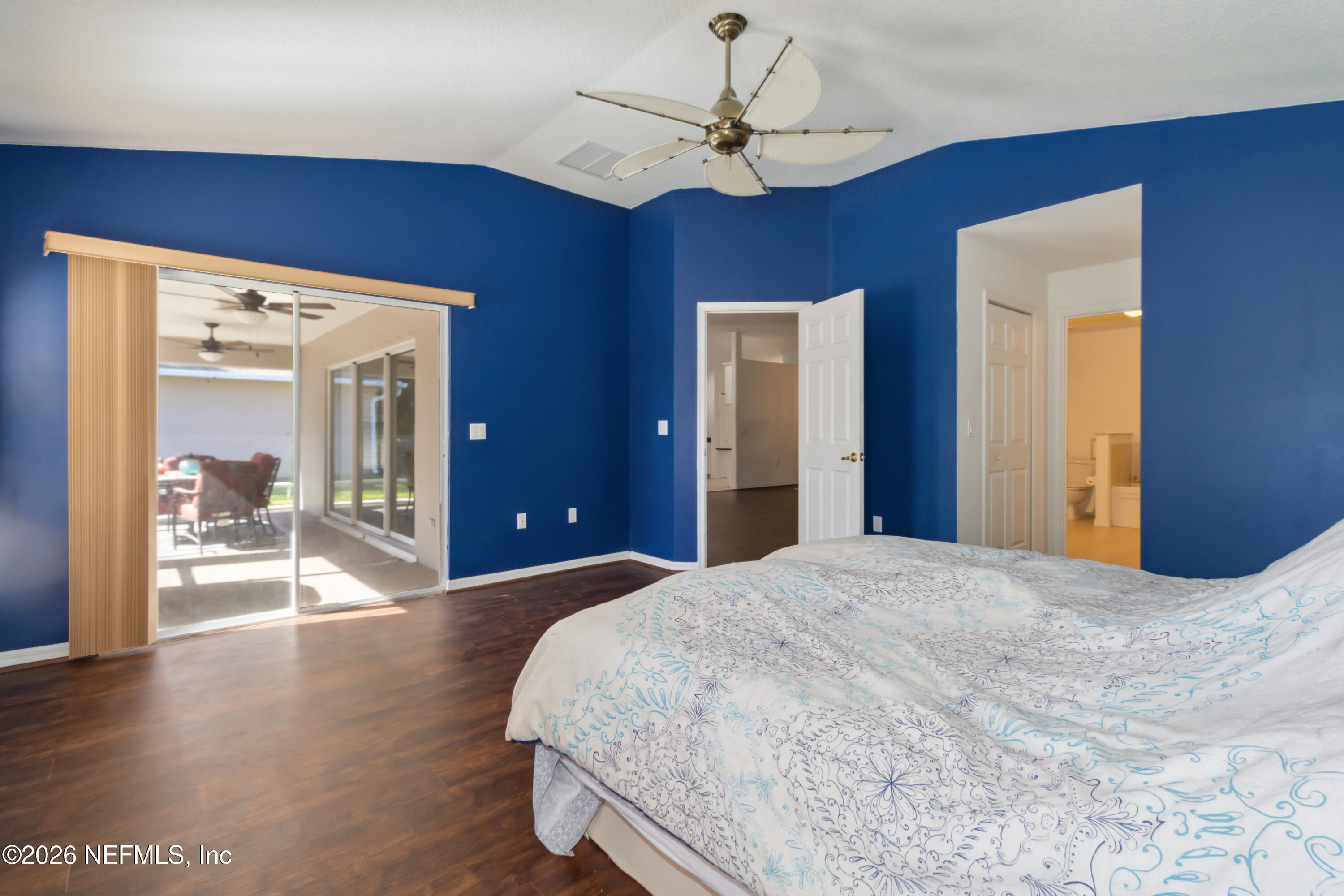940 Tavernier Circle Northeast Palm Bay, FL 32905 - Photo 20 of 31 a bedroom with a large bed and a chandelier
