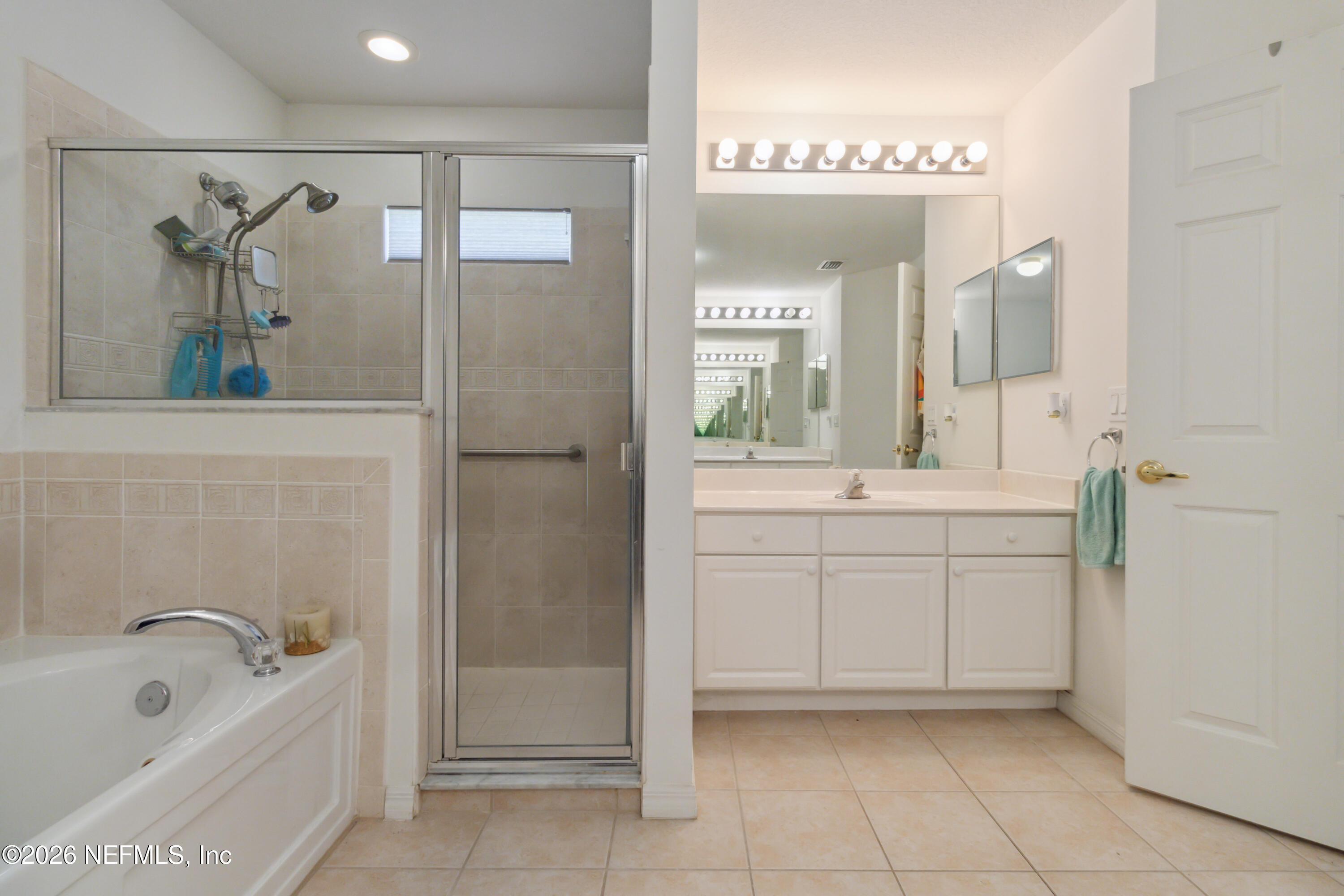 940 Tavernier Circle Northeast Palm Bay, FL 32905 - Photo 21 of 31 a bathroom with a tub sink and mirror