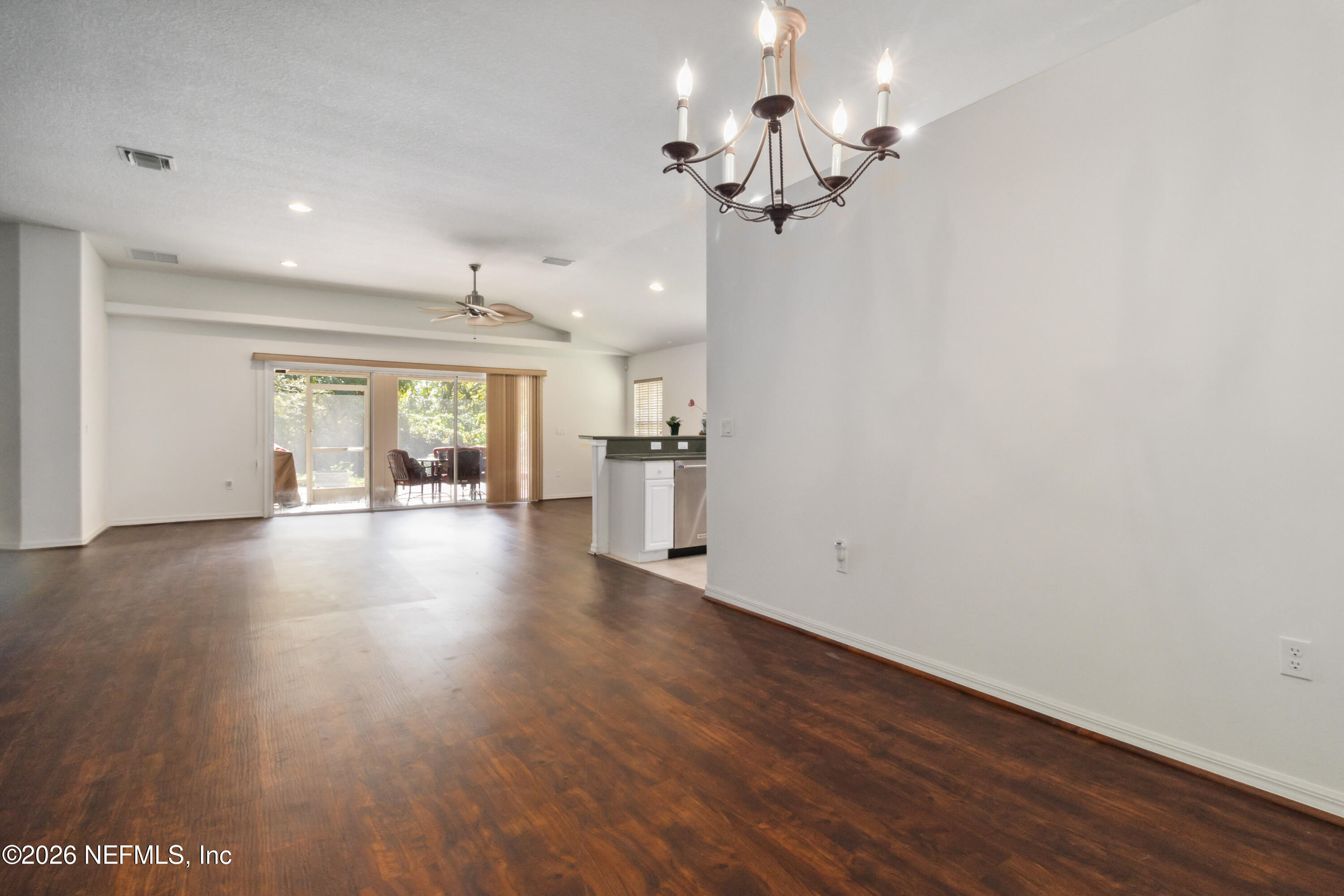 940 Tavernier Circle Northeast Palm Bay, FL 32905 - Photo 8 of 31 a view of a livingroom with hardwood floor and a ceiling fan