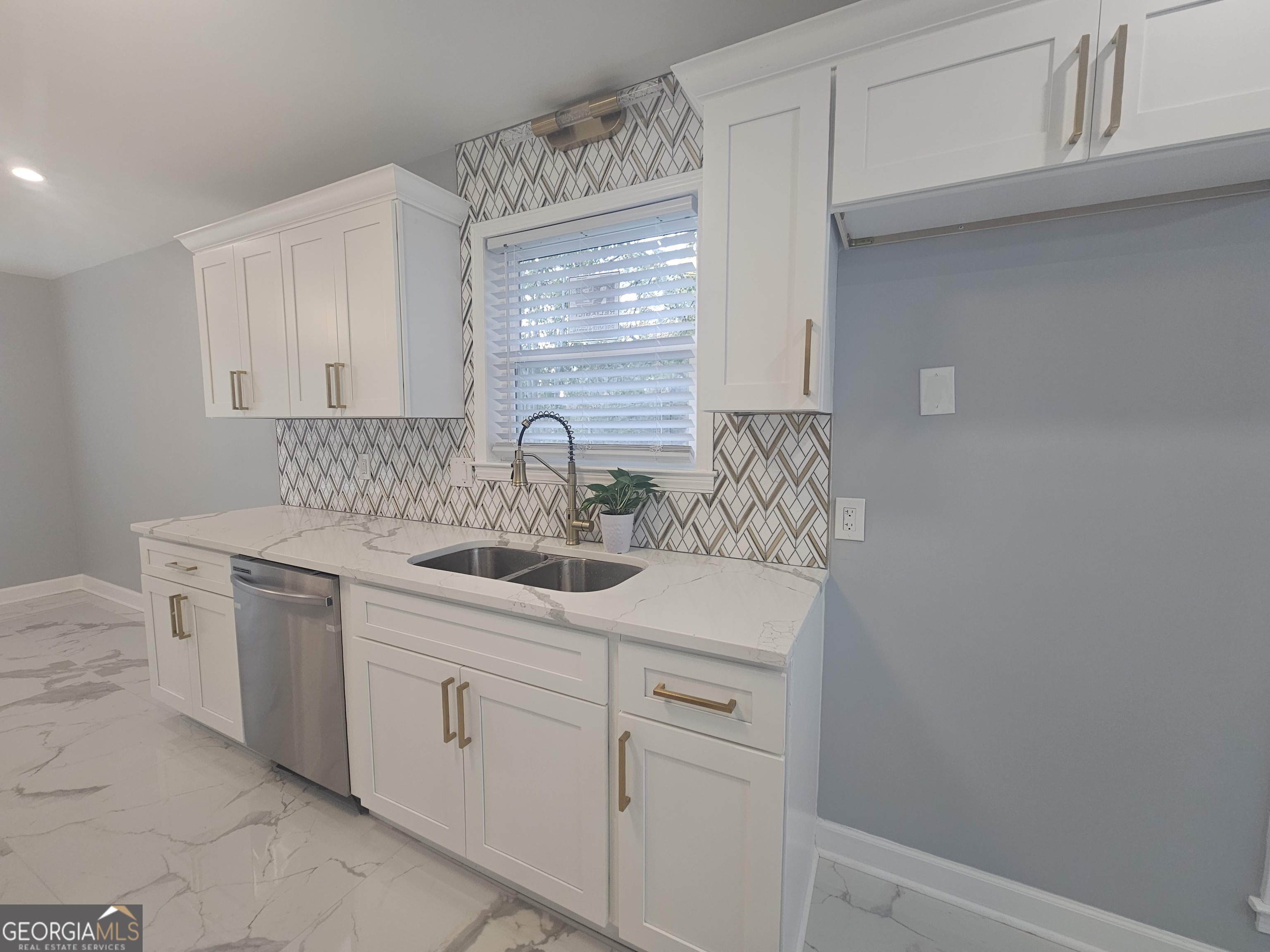 391 Park Ridge Circle Riverdale, GA 30274 - Photo 28 of 42 a kitchen with white cabinets appliances a sink and a window