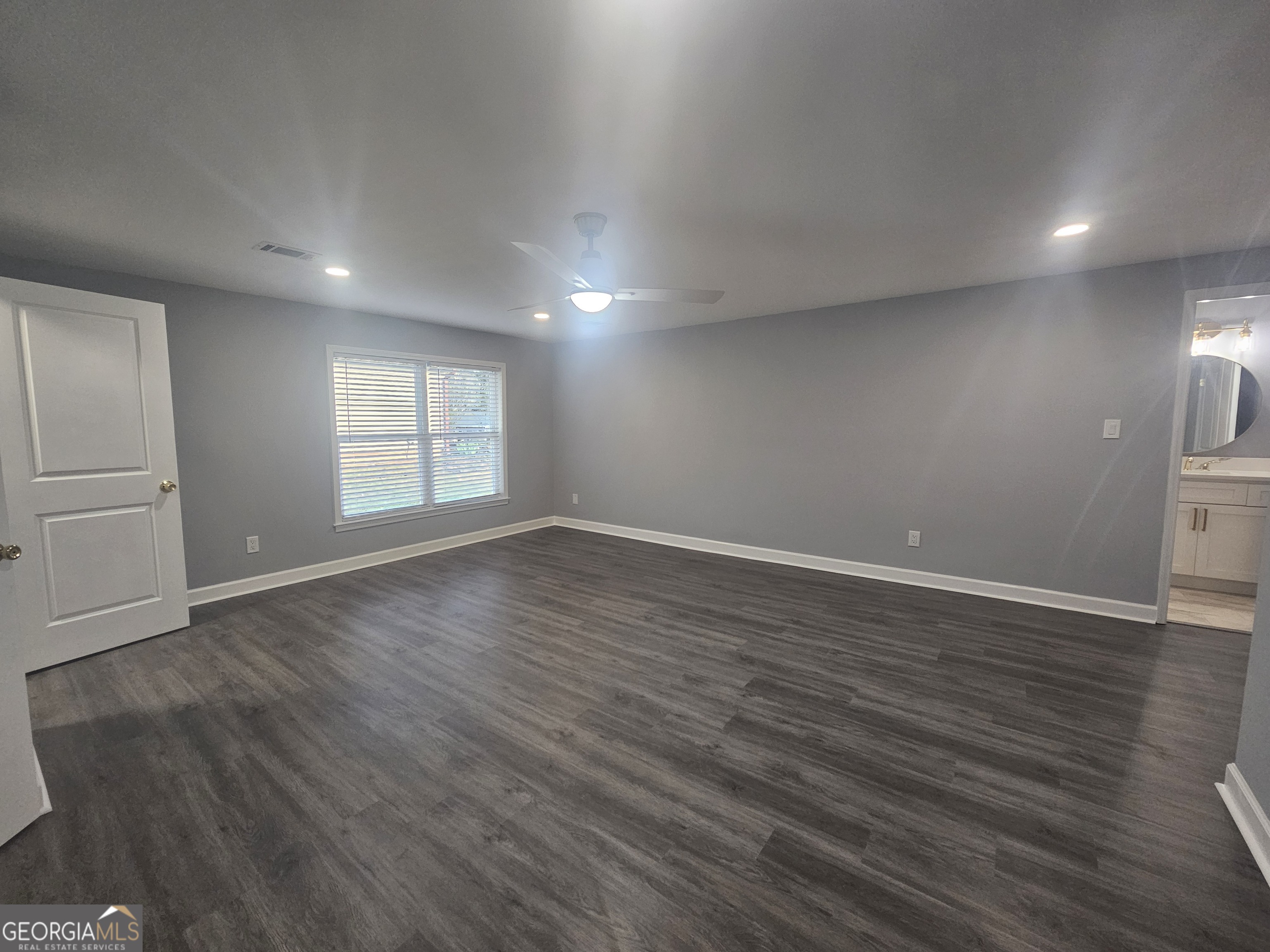 391 Park Ridge Circle Riverdale, GA 30274 - Photo 36 of 42 an empty room with wooden floor and windows