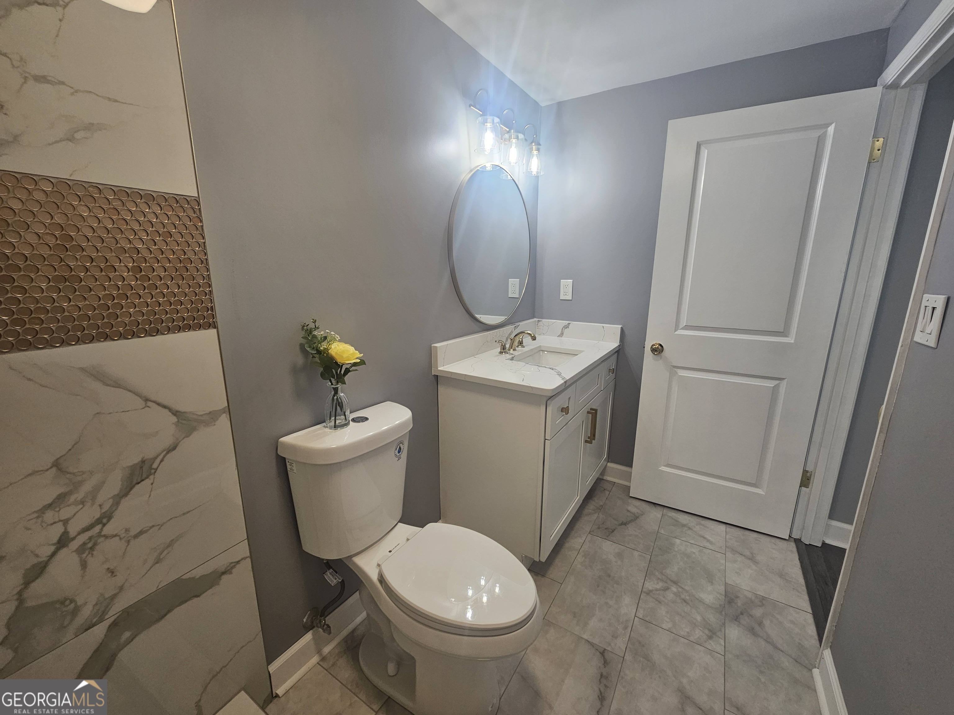 391 Park Ridge Circle Riverdale, GA 30274 - Photo 39 of 42 a white toilet sitting next to a bathroom sink and a mirror