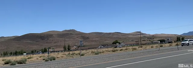 a view of a town with mountains in the background