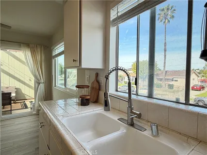 a kitchen with a sink and a large window