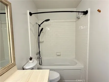a bathroom with a granite countertop bathtub shower and a sink