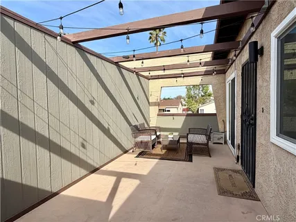 a view of a patio with table and chairs