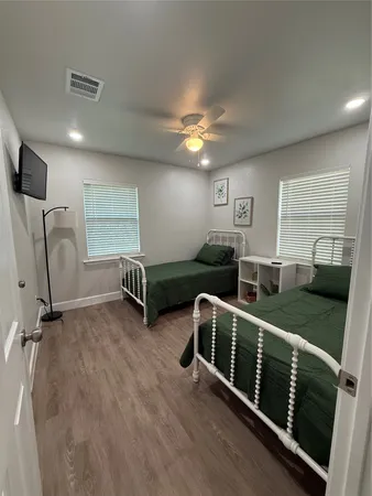 a view of a room with stairs wooden floor and windows