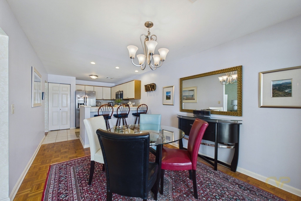 700 Shore Drive, Unit 509 Fall River, MA 02721 - Photo 11 of 25 a view of a dining room with furniture and a chandelier