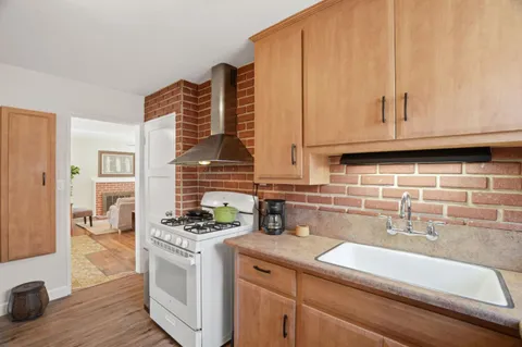 a kitchen with stainless steel appliances a sink a stove and cabinets