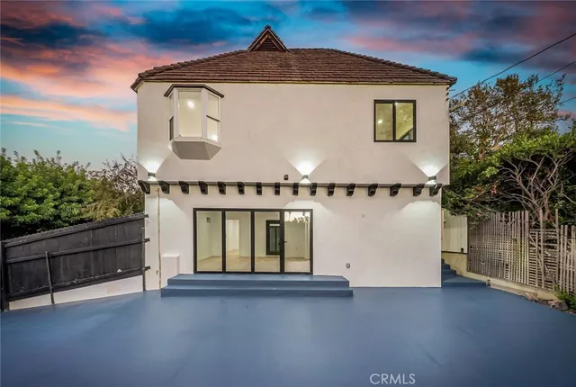 a view of a hallway with wooden floor and a chandelier