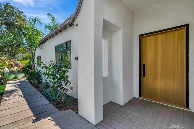 a large kitchen with a refrigerator a sink and a large window