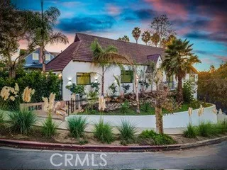a couple of flower plants in front of house