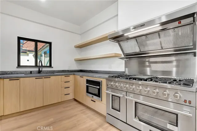 a kitchen with a sink stainless steel appliances and cabinets