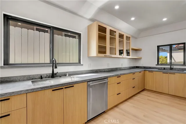 a kitchen with stainless steel appliances a sink stove and cabinets
