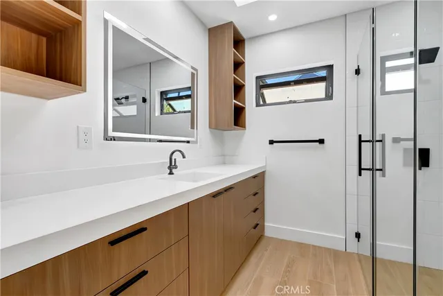 an empty room with closet and windows