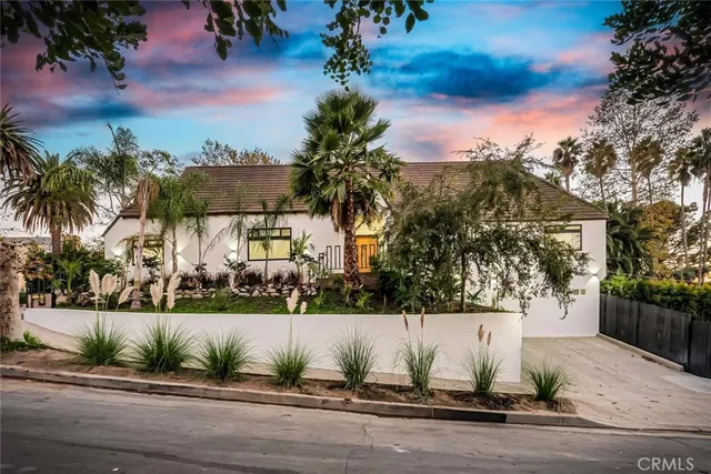 an aerial view of a house with garden space and street view