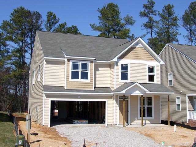 3245 Sunbright Lane Raleigh, NC 27610 - Photo 1 of 2 a front view of a house with a yard and garage