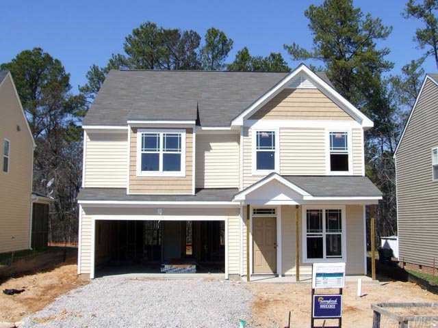 3245 Sunbright Lane Raleigh, NC 27610 - Photo 2 of 2 a front view of a house with a yard and garage