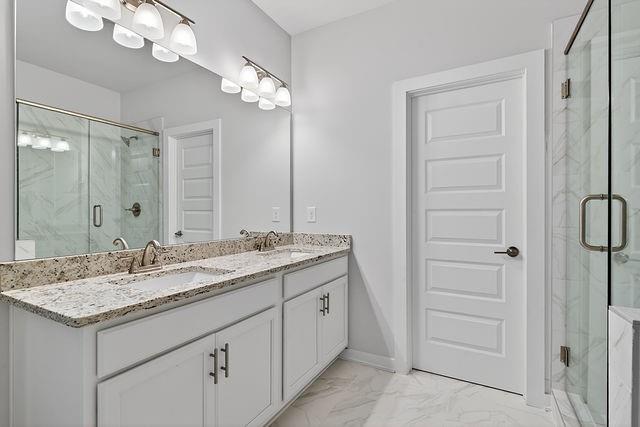 2562 Harbor Ridge Pass Gainesville, GA 30507 - Photo 26 of 27 a bathroom with a granite countertop sink a mirror and a vanity