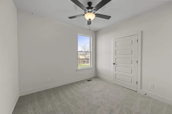 a view of room with window and ceiling fan
