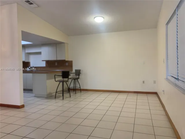 a view of a kitchen with cabinets and wooden floor