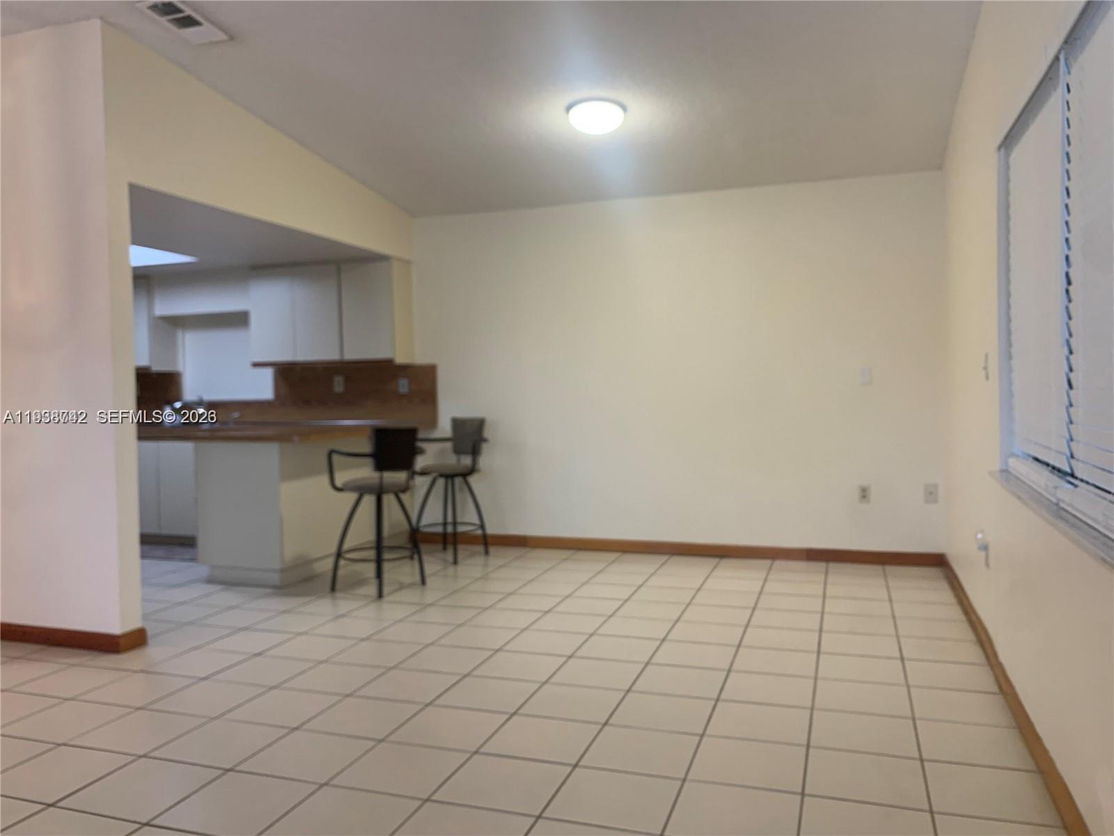 1261 Southwest 138th Court Miami, FL 33184 - Photo 5 of 11 a view of a kitchen with cabinets and wooden floor