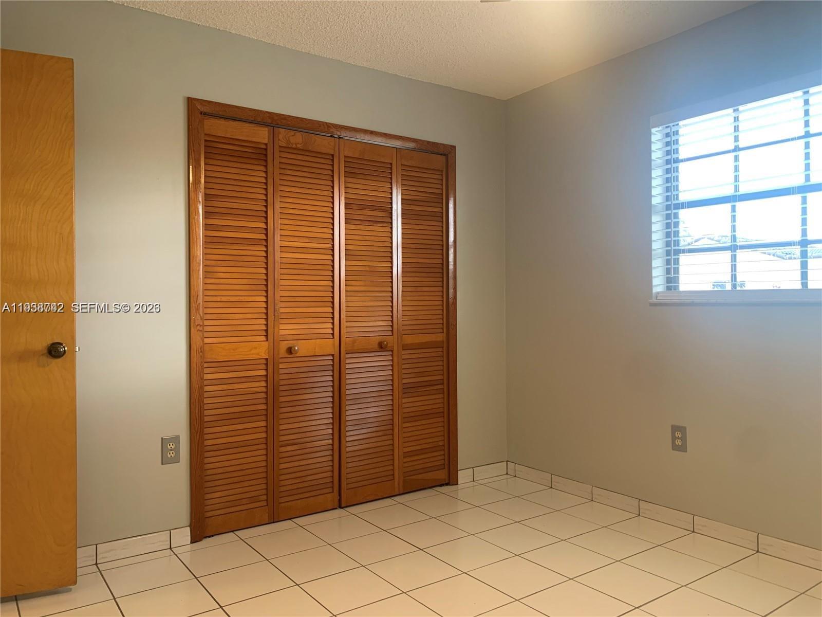 1261 Southwest 138th Court Miami, FL 33184 - Photo 7 of 11 an empty room with windows