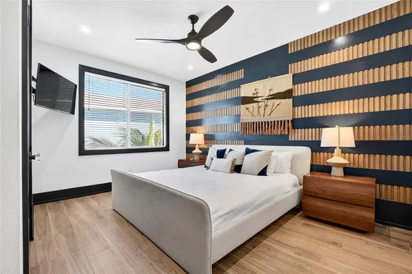 a view of a bedroom with furniture and windows