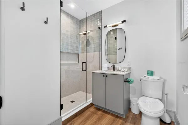 a bathroom with a toilet a sink and shower