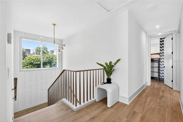 a view of hallway with window and stairs