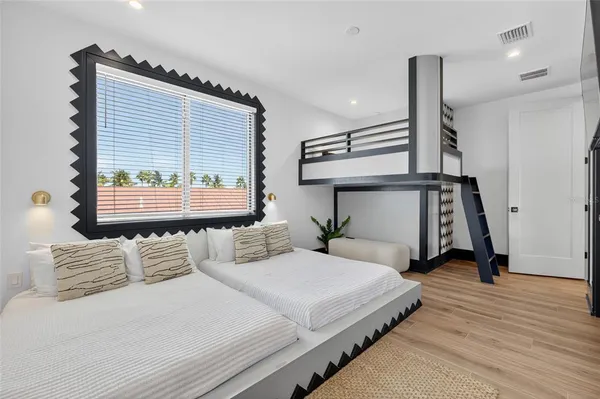 a bedroom with double bed and a window