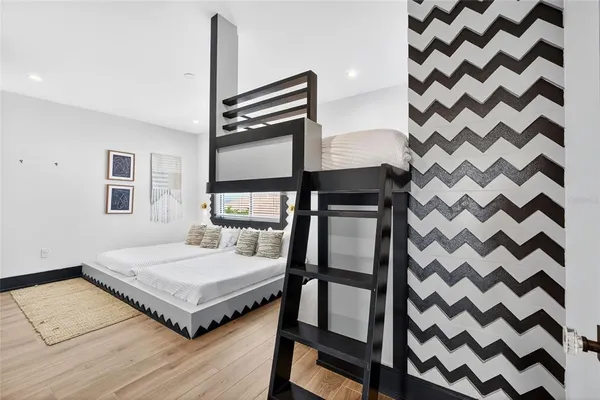 a bedroom with a bed and a black walk in closet