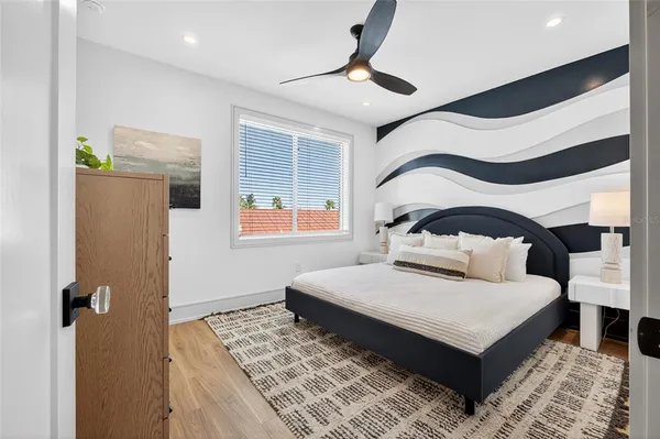 a bedroom with a bed and a window