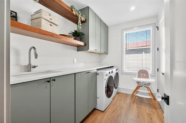 a utility room with cabinets dryer and washer