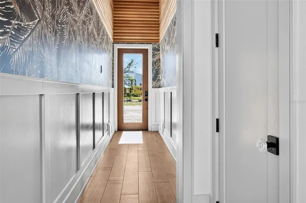 a view of a hallway with wooden floor